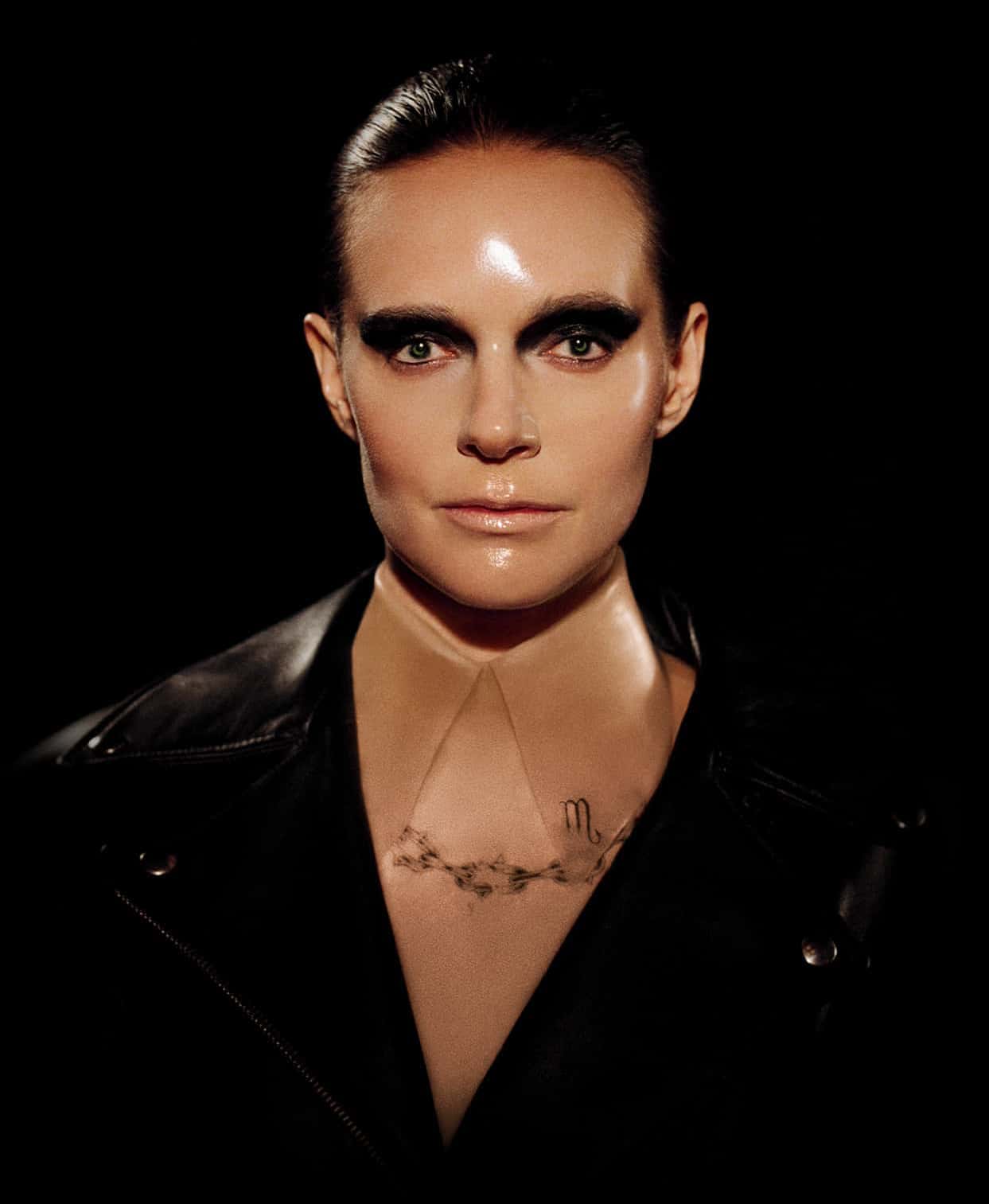 Photo of Tove Lo with slicked back hair wearing a black leather jacket
